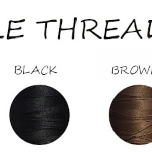 May include: Available thread colours for embroidery: white, grey, black, brown, neon orange, and red. Each colour is represented by a spool of thread.