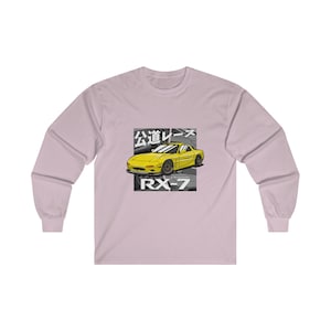 May include: A long-sleeved t-shirt with a yellow RX-7 car graphic and the Japanese text "公道レース" (meaning "street race") on a pink background.