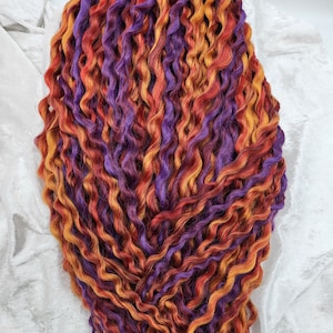 Curly Extensions with mixed assortment of Burgundy, Copper and Purple colors.