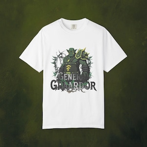 May include: White t-shirt featuring a green orc warrior graphic with the text "GENERAL GRAARDOR" in black and green. The orc is wearing armor with yellow accents. The design is set against a dark green background.