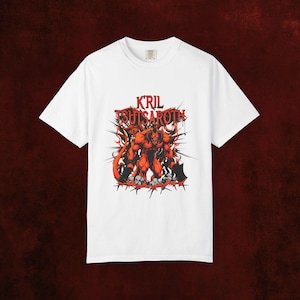 May include: White t-shirt with a red and orange graphic of a demon and the text "KRIL TSUTSAROTH". The illustration includes flames and spikes. The shirt has a crew neck and short sleeves. The design is bold and eye-catching.