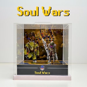 May include: A clear acrylic display case with a black base and a pink platform. The case features a 3D diorama of two characters from the video game Soul Wars. The diorama includes a green and brown character with a spear and a purple and gray character with a sword. The case has a black base with the text "Soul Wars" printed in white.