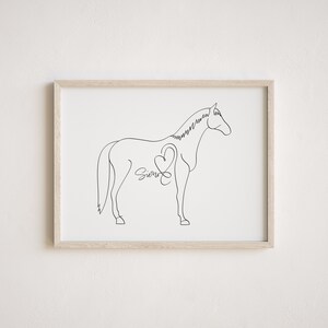 May include: Line art drawing of a horse with a heart and the name "Sierra" inside the heart. The drawing is in black and white and is framed in a light wood frame.