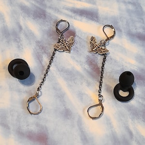 May include: A white ceramic mug with a black handle and the text "But First, Coffee" in a handwritten style. The mug is on a white surface. The mug is 4 inches tall.