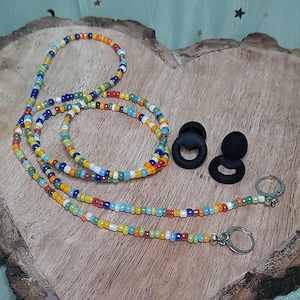 May include: A multi-coloured beaded eyeglass chain with small, round beads in red, orange, yellow, green, blue, and white. Two black earbud holders and two silver clasps are also visible.