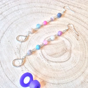May include: A pair of silver earrings with colorful agate beads. The beads are a mix of pink, blue, and white.