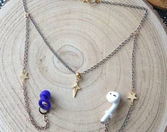 May include: A gold chain necklace with star charms and a small gold cross pendant. The necklace is attached to a pair of white wireless earbuds and a pair of blue silicone earbud tips.