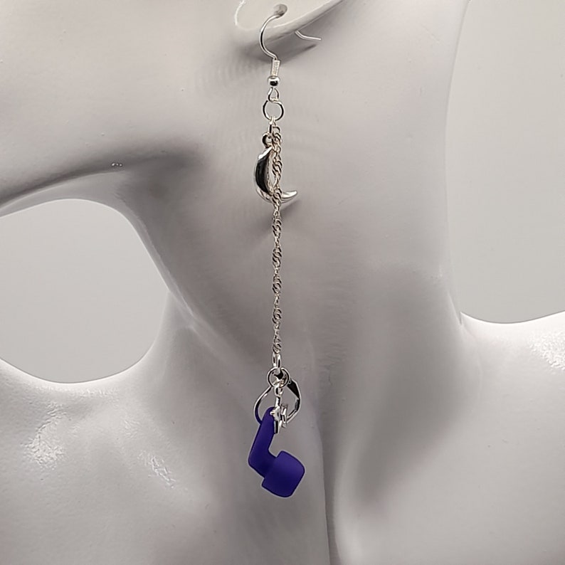 This image shows the moon and stars loop earplug earrings being worn with the loop earplug attached and just dangling down ready to be used.
