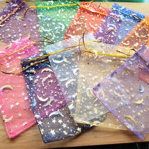 This image shows an example of the colours of the moon and stars organza gift bag that the earrings will be packaged in.