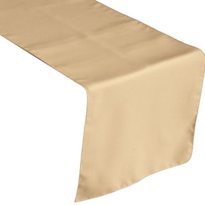 May include: A beige table runner made of satin fabric. The runner is 14 inches wide and 72 inches long.