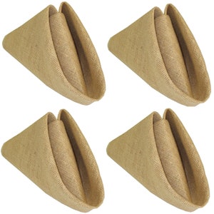 May include: Set of four brown burlap napkins folded into a triangular shape. The napkins are made from a natural material and have a rustic look.