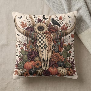 Pillow with cow skull, sunflowers, pumpkins, and fall leaves design.
