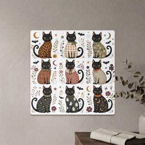 Nine black cats with decorative outfits and Halloween motifs on a white background.