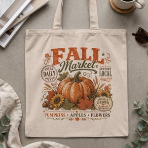 Canvas tote bag with "Fall Market" design featuring pumpkin, sunflowers, and text.