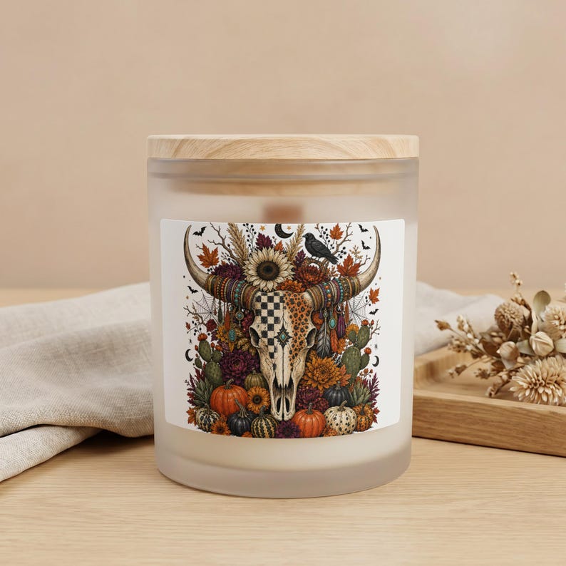 Frosted glass candle with a western-themed skull, pumpkins, and fall foliage label.