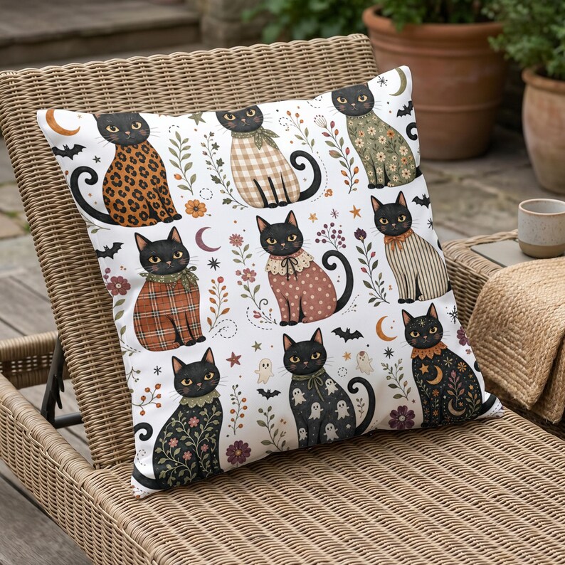 Decorative pillow with a pattern of black cats in various outfits and Halloween motifs.
