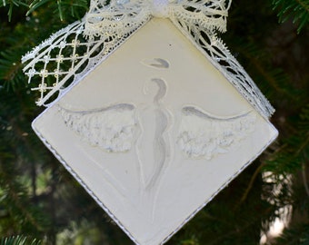 Painted angels on the Christmas tree. Hand painted. Silver ornament. Acrylic painting on canvas.