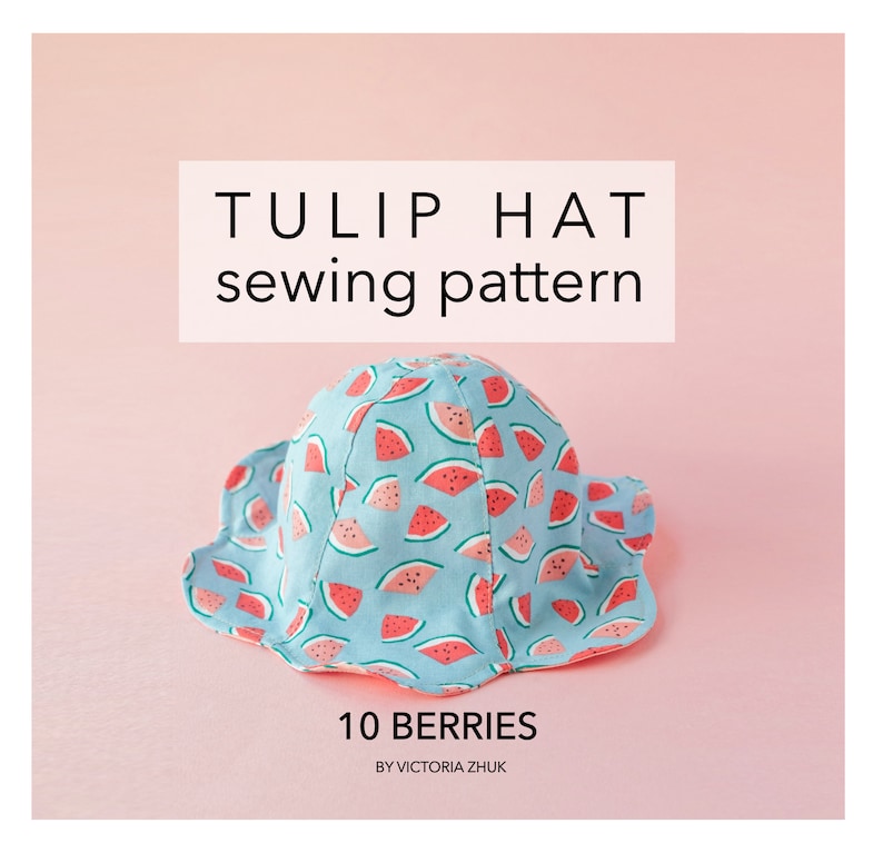May include: A sewing pattern for a tulip hat with a watermelon print. The pattern is called "10 Berries" by Victoria Zhuk.