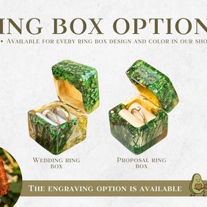 May include: Image shows two open ring boxes with gold rings inside. The boxes are green and gold with a textured design. Text reads "RING BOX OPTIONS" and "WEDDING RING BOX" and "PROPOSAL RING BOX". The engraving option is available.
