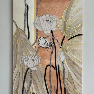 May include: A rectangular wall art piece featuring a stylized lotus flower design. The artwork displays white lotus blossoms, a seed pod, and large leaves with gold-colored outlines. The background consists of a peach-toned marble pattern.