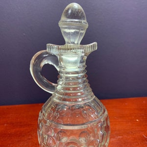 Vintage Clear Cruet with 4 Pour Spouts, Ribbed Neck, with a Thumbprint Pattern on the Base.  Original stopper.