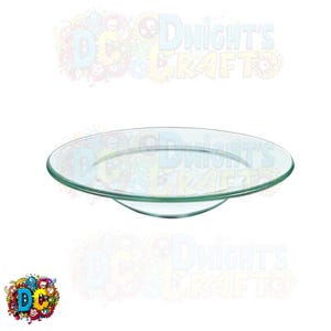 May include: A clear glass plate with a slightly raised edge. The plate is round and has a smooth surface.