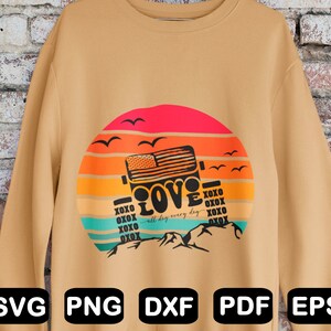 May include: A tan sweatshirt featuring a graphic design of a jeep driving through a sunset with the words "XOXO LOVE XOXO all day every day XOXO XOXO XOXO" printed on it.