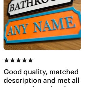 May include: A close-up of three decorative signs. The top sign is pink with white text that reads "SKYES ROOM". The middle sign is black with white text that reads "BATHROOM". The bottom sign is orange with blue text that reads "ANY NAME".