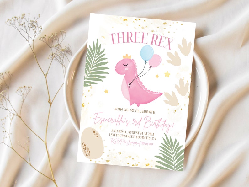 May include: A pink dinosaur with a crown and balloons, surrounded by green leaves and gold glitter. The text "THREE REX" is at the top of the card. The text "JOIN US TO CELEBRATE Esmeralda's 3rd Birthday!" is in the middle of the card. The text "SATURDAY, AUGUST 24 AT 2PM 1234 YOUR STREET, YOUR CITY, CA RSVP" is at the bottom of the card.