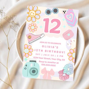 May include: A colourful birthday invitation featuring the number 12 in pink, with illustrations of flowers, sunglasses, a phone case, a purse, a camera, a bow, and scrunchies. The invitation text reads "Join us to celebrate Olivia's 12th Birthday!"