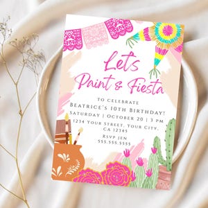 May include: A colourful invitation for a birthday party with the text "Let's Paint & Fiesta" and details for Beatrice's 10th birthday party. The invitation features a festive design with cacti, flowers, and a piñata.