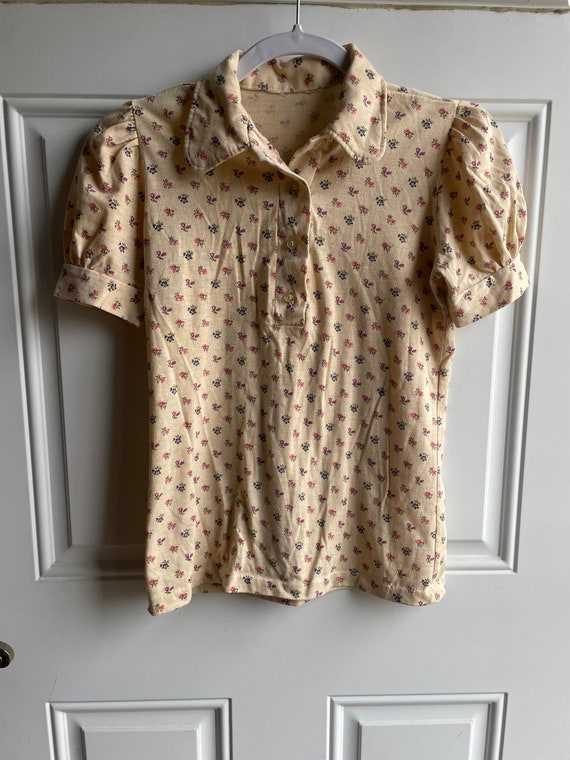 70’s floral polo with navy and pink flowers on a b