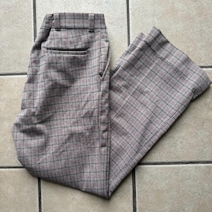 May include: A pair of brown and pink plaid pants with a wide leg.