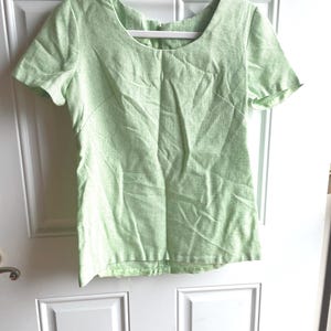 Vintage 70’s light green blouse with shirt sleeves and scoop neckline.