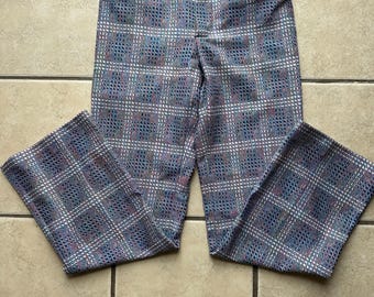 May include: A pair of plaid pants with a blue, pink, and white pattern. The pants have a wide leg and a high waist.