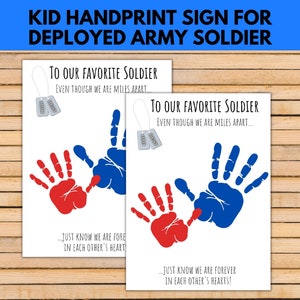 May include: A printable sign with the text "To Our Favourite Soldier Even Though We Are Miles Apart... Just Know We Are Forever In Each Other's Hearts!" The sign features two handprints, one red and one blue, and two silver dog tags with the text "MOM" and "DAD".