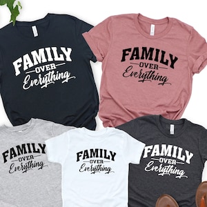 May include: A set of five t-shirts in different colors with the text "Family Over Everything" printed on them. The shirts are arranged in a pyramid shape with the largest shirt at the top and the smallest shirts at the bottom.