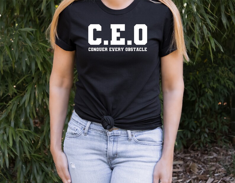 May include: Black t-shirt with white text that reads "C.E.O. CONQUER EVERY OBSTACLE"