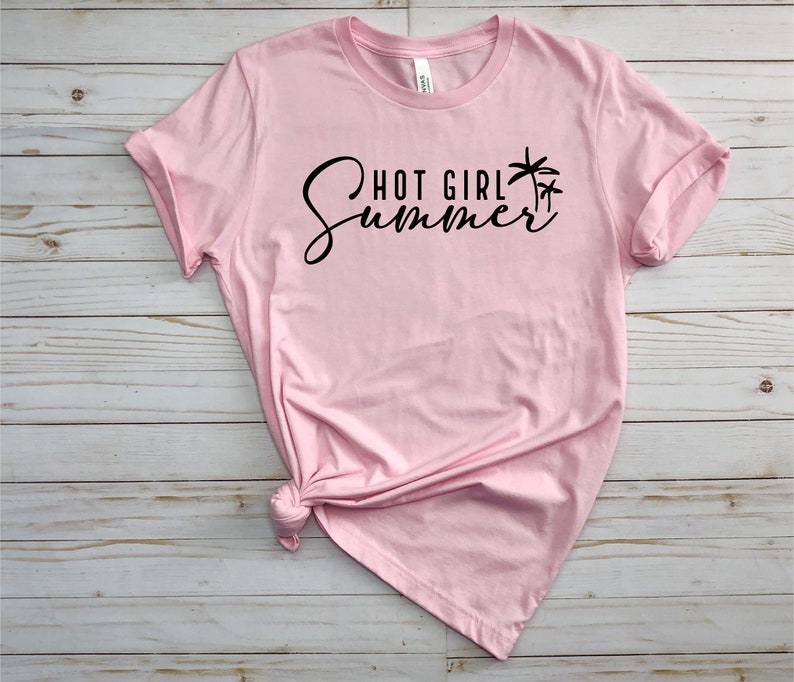 May include: Pink t-shirt with black text that reads "Hot Girl Summer" and a palm tree graphic.