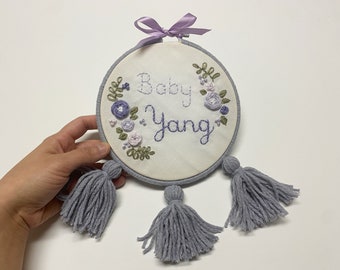 Personalized hand-embroidered hoop wall hanging with yarn tassels. Baby name announcement. Name wall hanging. Customized newborn baby gift.