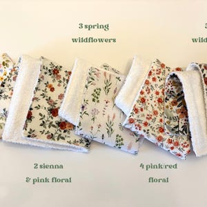 May include: A collection of floral patterned fabric squares with white terrycloth borders. The squares feature various floral designs in colors like pink, red, and yellow. Text on the image reads: "1 ribbons & floral", "3 spring wildflowers", "5 fall wildflowers", "2 sienna & pink floral", and "4 pink/red floral".