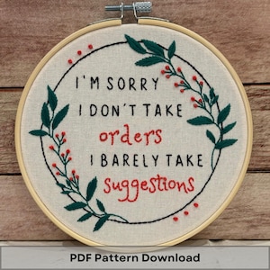 Peut inclure: Art de broderie sur un cercle avec une couronne de feuilles vertes et des baies rouges. Le texte dit "Je suis désolé, je ne prends pas de commandes, je prends à peine des suggestions".