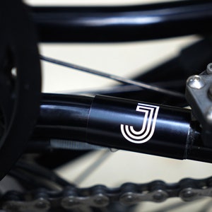 Customizable laser-engraved rear triangle frame protector for Brompton