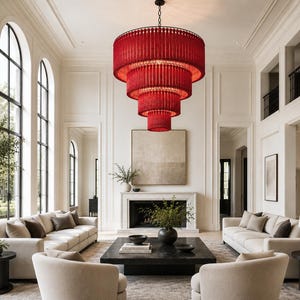 May include: A large, multi-tiered chandelier featuring vibrant red beaded fringe hanging in a cascading circular design. The fixture is suspended from a central point, showcasing four distinct levels of red strands that create a bold focal point.