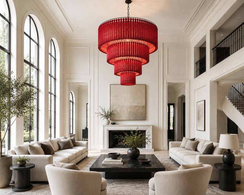 May include: A large, multi-tiered chandelier featuring vibrant red beaded fringe hanging in a cascading circular design. The fixture is suspended from a central point, showcasing four distinct levels of red strands that create a bold focal point.