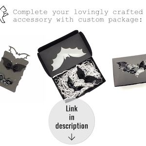 May include: Black bat-shaped hair clips in a black box with a bat cut-out. The box is filled with white tissue paper. The text "Complete your lovingly crafted accessory with custom package: Link in description" is above the image.