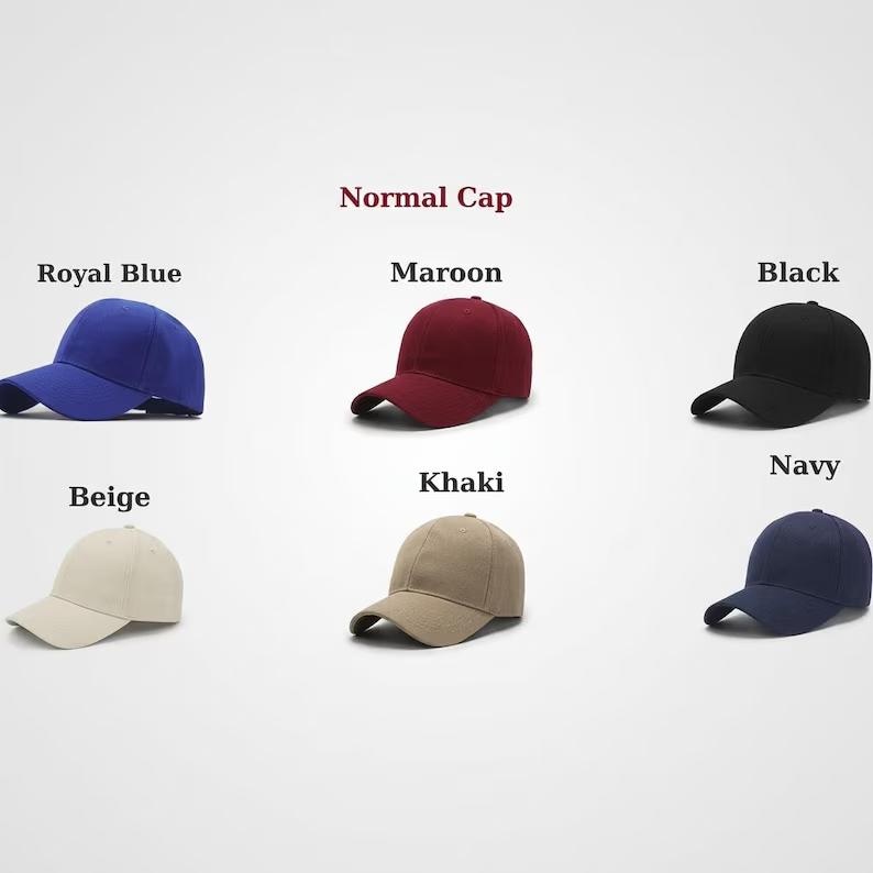 May include: A collection of six baseball caps labeled Normal Cap, displayed in royal blue, maroon, black, beige, khaki, and navy. Each cap features a structured crown, a curved brim, and a solid color design, arranged in two rows for comparison.
