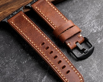 May include: Two brown leather watch bands with white stitching and black metal clasps.