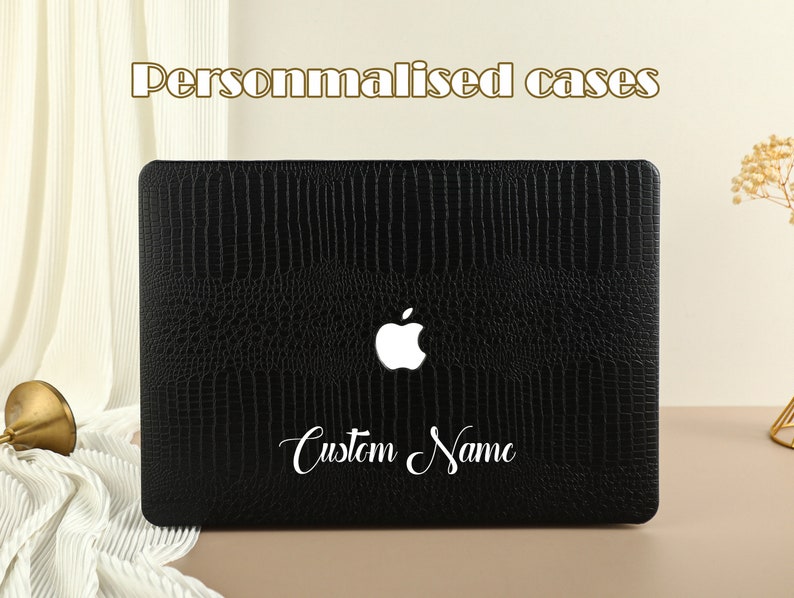 May include: Black laptop case with a crocodile pattern and a white Apple logo. The case has a white inscription that says "Custom Name".
