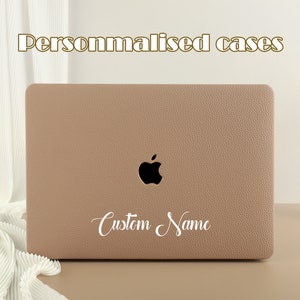 May include: A light brown laptop case with a black Apple logo and the text "Custom Name" in white cursive writing.